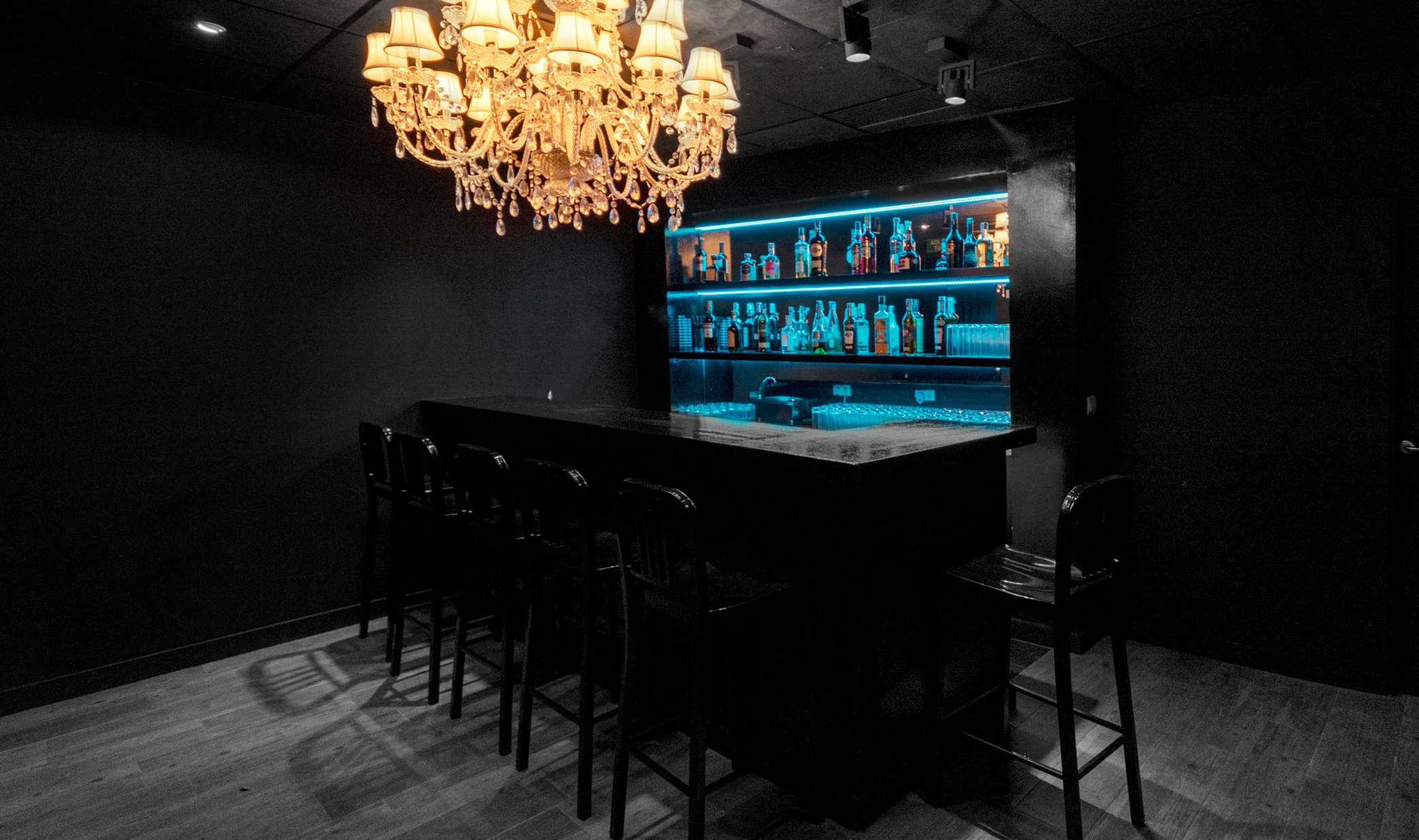 Private bar with chandelier and LED lighting at BADDIES VILLA